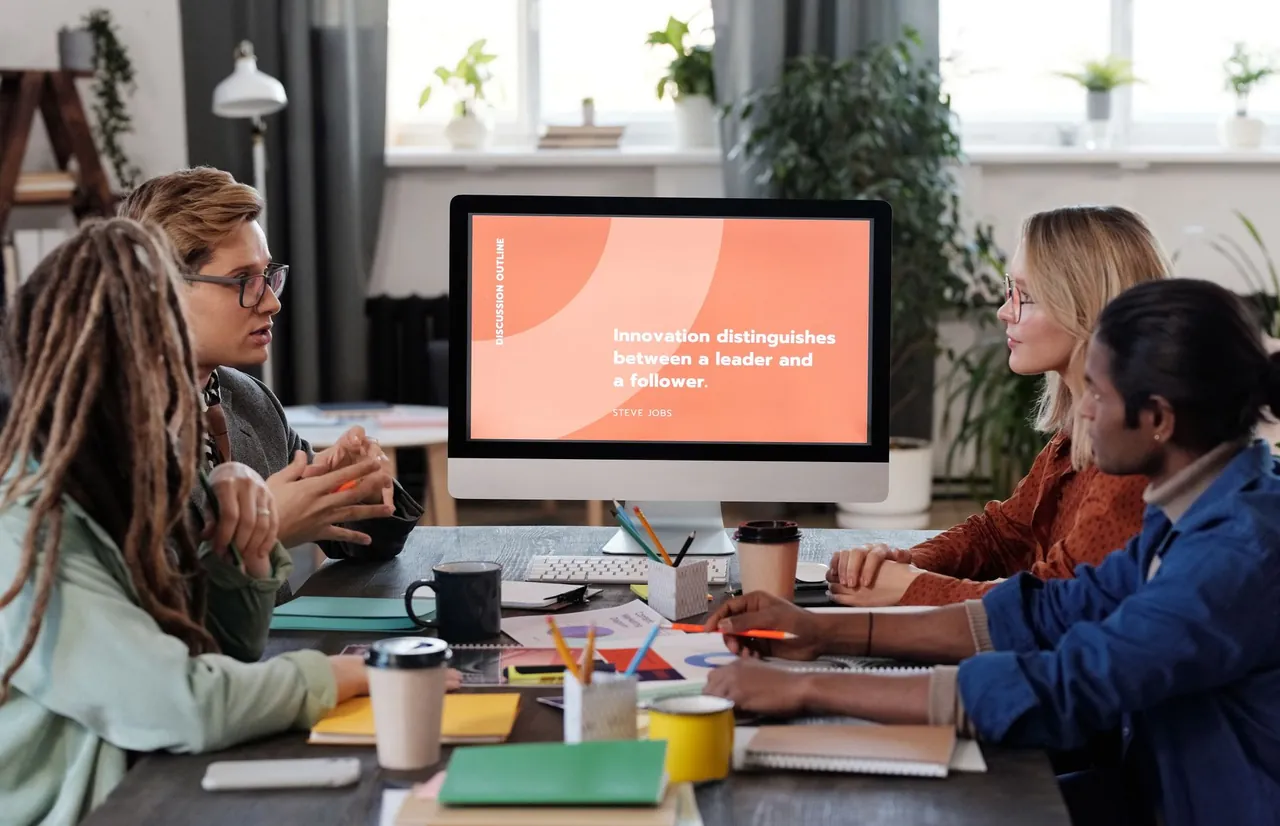 Product team collaborating around a digital presentation